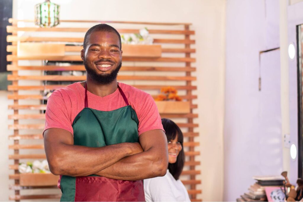 Barbershop owner smiling.